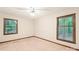 Neutral bedroom with carpet flooring, two windows providing natural light, and ceiling fan at 3985 Well Rd, Mint Hill, NC 28227