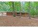 Brick home with a charming entrance, surrounded by lush greenery and mature trees on a spacious lot at 3985 Well Rd, Mint Hill, NC 28227