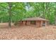 Brick home with wooded lot features a back deck, attached garage, and mature landscaping for a private retreat at 3985 Well Rd, Mint Hill, NC 28227