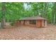 A single Gathering brick home with large windows and a wooden deck at 3985 Well Rd, Mint Hill, NC 28227
