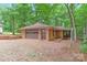 A detached garage with brick construction featuring a brown door and brick-paved driveway at 3985 Well Rd, Mint Hill, NC 28227