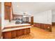 Eat-in kitchen featuring warm wood cabinetry and trim, with a peninsula counter separating the kitchen and eating area at 3985 Well Rd, Mint Hill, NC 28227