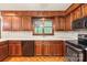 Well-appointed kitchen with wood cabinets, black appliances, and ample counter space, perfect for meal preparation at 3985 Well Rd, Mint Hill, NC 28227