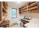 Functional laundry room with shelving, sink, and window at 3985 Well Rd, Mint Hill, NC 28227