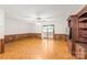 Inviting living room with wood paneling, a sliding glass door to the backyard deck, and built-in shelving at 3985 Well Rd, Mint Hill, NC 28227