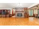 Comfortable living room with parquet floors, brick fireplace, and built-in cabinets, perfect for gatherings at 3985 Well Rd, Mint Hill, NC 28227