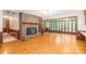 Elegant living room showcasing a brick fireplace, built-in shelving, and views into a bright sunroom at 3985 Well Rd, Mint Hill, NC 28227