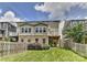 A well-maintained backyard featuring a deck, a brick facade, and a wooden fence at 402 Belton St, Charlotte, NC 28209