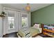 Charming bedroom with ample natural light features a green accent wall and stylish furnishings at 402 Belton St, Charlotte, NC 28209