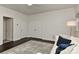 Bright bedroom with modern white walls, dark wood floor, and a comfortable seating area at 402 Belton St, Charlotte, NC 28209