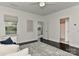 Bright bedroom with dark floors, ceiling fan, neutral rug, and access to an ensuite bathroom at 402 Belton St, Charlotte, NC 28209