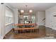 Bright dining area features hardwood floors, large windows, modern lighting, and is open to the kitchen, creating a seamless flow at 402 Belton St, Charlotte, NC 28209
