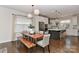 Bright dining area with a stylish table, bench, and modern lighting, seamlessly connecting to the open-concept kitchen at 402 Belton St, Charlotte, NC 28209