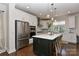 Bright kitchen featuring stainless steel appliances, center island with bar seating, and dark hardwood floors at 402 Belton St, Charlotte, NC 28209