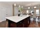 Kitchen island with white countertop, with a dining area and living area in the background at 402 Belton St, Charlotte, NC 28209