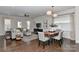 Inviting living room featuring hardwood floors, modern lighting, comfortable seating, and seamlessly connects to the dining area at 402 Belton St, Charlotte, NC 28209