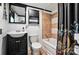 Bathroom featuring tiled shower-tub combo and vanity with black cabinets and sink at 407 Rosemont Ave, Kannapolis, NC 28081