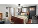 Bedroom featuring dark accent wall, hardwood floors, curtains, and a ceiling fan at 407 Rosemont Ave, Kannapolis, NC 28081