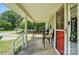 View from covered porch with outdoor seating, plus a view of a road and car at 407 Rosemont Ave, Kannapolis, NC 28081