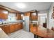 Well-lit kitchen showcases wooden cabinets, stainless steel refrigerator, and a wooden table at 407 Rosemont Ave, Kannapolis, NC 28081