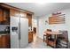 Bright kitchen with stainless steel refrigerator, wood cabinets, and a breakfast nook area at 407 Rosemont Ave, Kannapolis, NC 28081