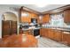 Traditional eat-in kitchen featuring wood cabinets, a microwave, and a stove oven at 407 Rosemont Ave, Kannapolis, NC 28081