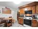 Cozy kitchen with wood cabinets, laminate floors, and a round table with chairs at 407 Rosemont Ave, Kannapolis, NC 28081