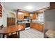 Kitchen with wood cabinets, stainless steel appliances, and light-colored wood floors at 407 Rosemont Ave, Kannapolis, NC 28081