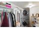 Laundry room with stacked washer-dryer and laundry accessories, showing great home features at 407 Rosemont Ave, Kannapolis, NC 28081