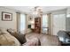 Bright living room featuring wood floors, a ceiling fan, and large windows at 407 Rosemont Ave, Kannapolis, NC 28081