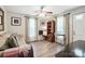 Living room featuring hardwood floors, light walls, bright windows, and a gray sofa at 407 Rosemont Ave, Kannapolis, NC 28081