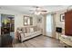 Cozy living room with hardwood floors, ceiling fan, and neutral-colored sofa with pillows at 407 Rosemont Ave, Kannapolis, NC 28081