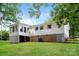 Rear exterior view of home with brick foundation and screened-in porch addition at 4308 Pinto Ln, Gastonia, NC 28052