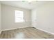 Bright bedroom featuring neutral walls, modern ceiling fan, and wood-look flooring at 4308 Pinto Ln, Gastonia, NC 28052