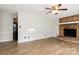 Open living room featuring a brick fireplace, hardwood floors, and lots of light at 4308 Pinto Ln, Gastonia, NC 28052
