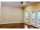 Bright bedroom with hardwood floors and French doors that lead to a private balcony with railings at 6184 Chandler Rd, Clover, SC 29710