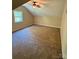 Spacious carpeted bedroom featuring a ceiling fan and natural light from a window at 6184 Chandler Rd, Clover, SC 29710