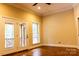 Bedroom with hardwood floors and French doors that lead to a private balcony with a railing at 6184 Chandler Rd, Clover, SC 29710