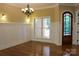Bright dining room with white wainscoting, chandelier and large window adding charm and elegance at 6184 Chandler Rd, Clover, SC 29710