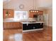 Open kitchen featuring a black island with light countertops, stainless steel appliances, and modern lighting at 6184 Chandler Rd, Clover, SC 29710