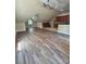 Open-concept living area with wood-look tile flooring and neutral walls at 6184 Chandler Rd, Clover, SC 29710