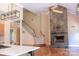 Living room featuring a stone fireplace, hardwood floors, and staircase at 6184 Chandler Rd, Clover, SC 29710