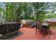 Back deck features a grill, dining table with chairs, and additional seating at 6706 Farrington Ln, Charlotte, NC 28227