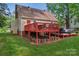 Exterior view of a home with a back deck, an outdoor living space, and a grassy yard at 6706 Farrington Ln, Charlotte, NC 28227