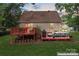 Exterior view of a home with a back deck, an outdoor living space, and a grassy yard at 6706 Farrington Ln, Charlotte, NC 28227