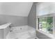 Bright bathroom featuring a soaking tub and window at 6706 Farrington Ln, Charlotte, NC 28227