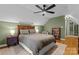 Bedroom with pitched ceiling, ceiling fan, hardwood floors, and a queen bed at 6706 Farrington Ln, Charlotte, NC 28227