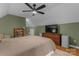 Bedroom with pitched ceiling, ceiling fan, hardwood floors, and a bookcase at 6706 Farrington Ln, Charlotte, NC 28227