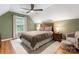 Bright bedroom with a queen bed, ceiling fan and natural light at 6706 Farrington Ln, Charlotte, NC 28227
