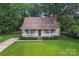 Charming front of house with inviting porch and well-manicured lawn at 6706 Farrington Ln, Charlotte, NC 28227